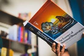 A devotee holding a Bhakti Marga publication in a bookshop