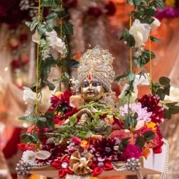 A deity adorned with flowers for a festival